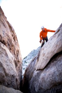 man standing on rock formation photo