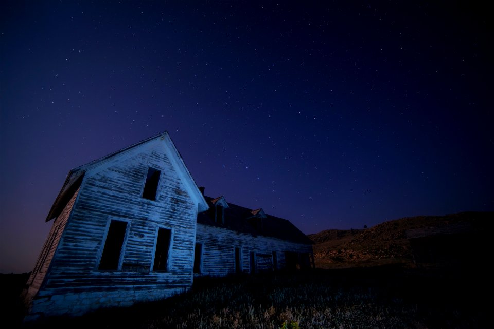 house on field under sky with stars