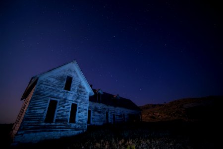 house on field under sky with stars photo