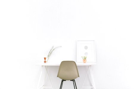 white wooden table near brown chair photo
