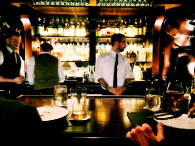 bartender standing beside table
