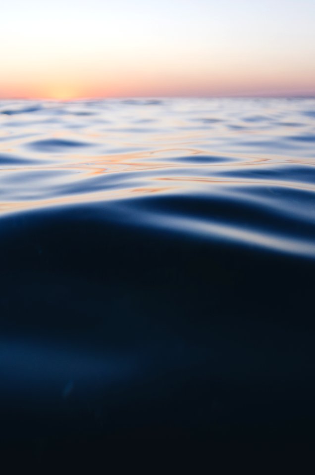 photo of calm sea water during daytime photo