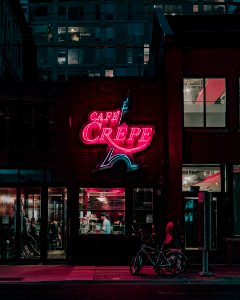 two people standing in front of Cafe Crepe storefront