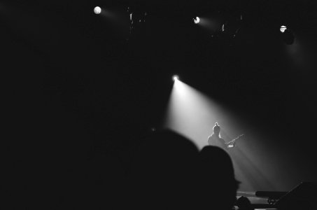 person playing guitar on stage photo