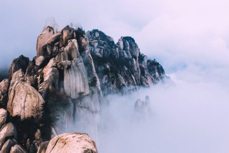 rock formation surrounded with fogs photo