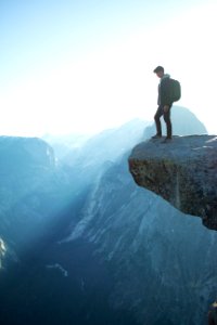 man standing on cliff photo