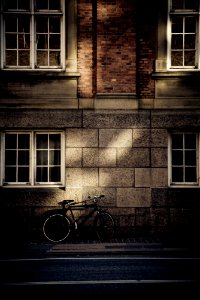 black mountain bicycle in front of brown concrete house