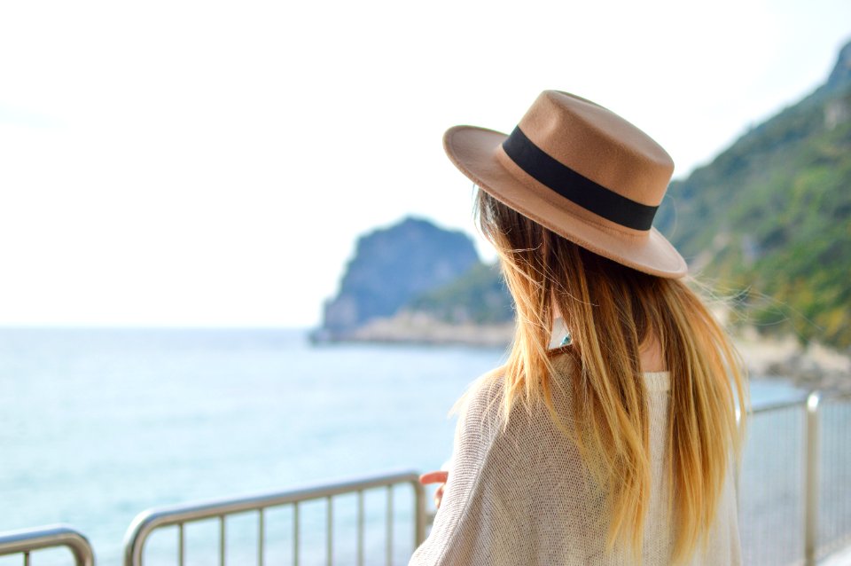 woman standing near body of water at daytime