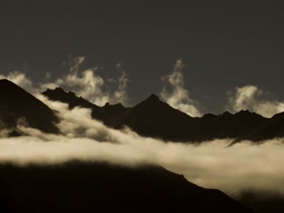 mountains surrounded by sea of clouds during daytime photo