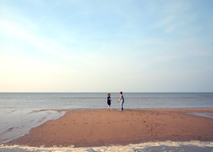 two woman playing in shoreline photo