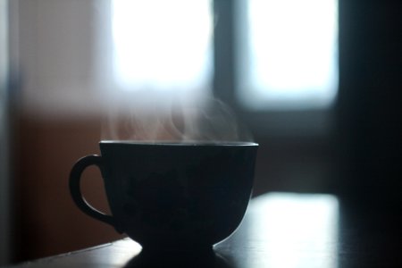 black ceramic teacup on table photo