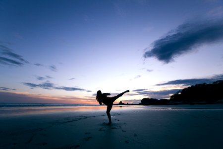 silhouette of person kicking on mid air photo