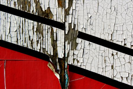 scratched white and red painted wall