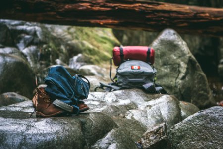 two gray and orange backpacks on gray rocks at daytime photo