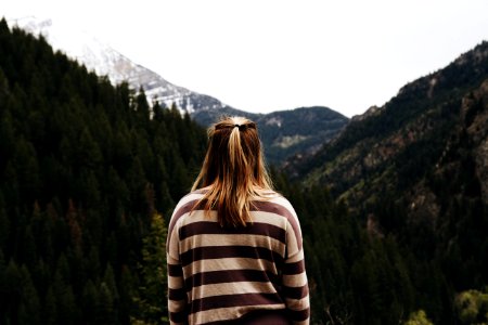woman wearing striped long-sleeved shirt facing mountains photo