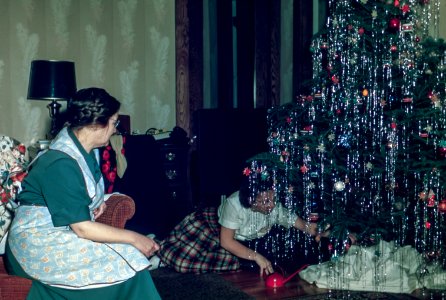 woman sitting under Christmas tree photo