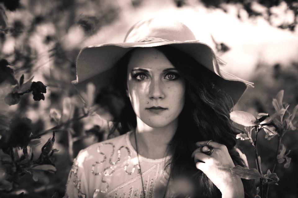 grayscale photography of woman wearing sun hat