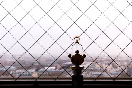 gray and brass-colored telescope facing city buildings photo