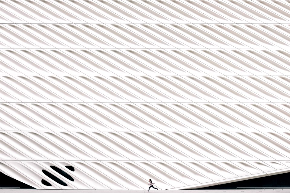 person running near white painted wall