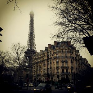 Eiffel Tower behind concrete building photo