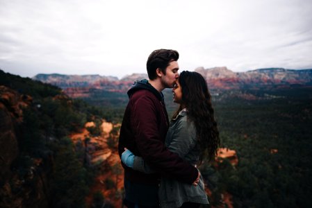 man kissing woman's forehead photo