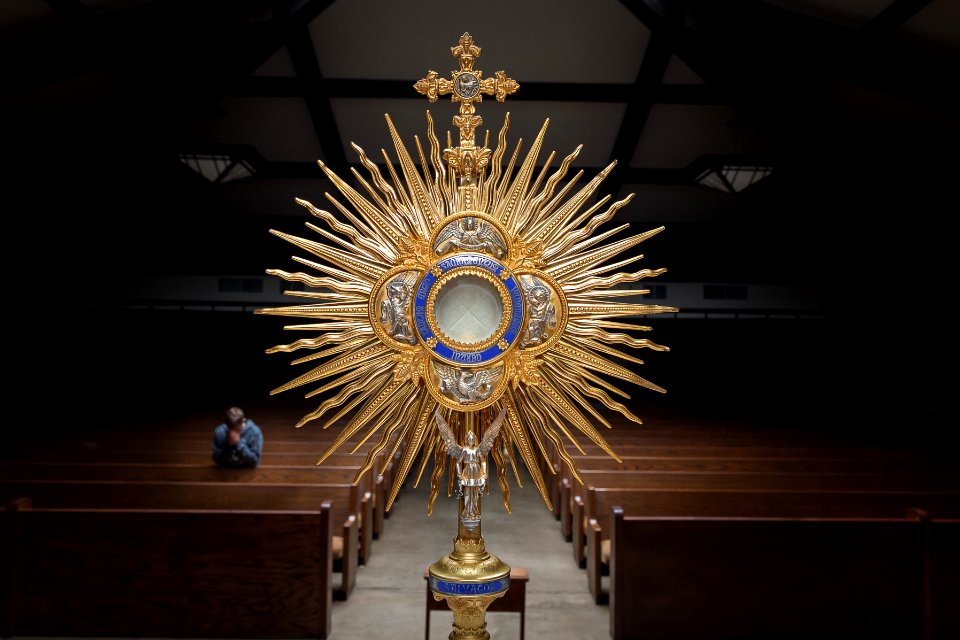 gold-colored cross table decor on top of brown wooden table