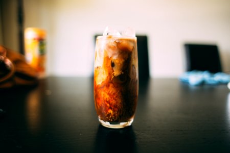 brown liquid inside clear drinking glass photo