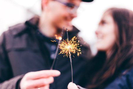 man and woman holding fireworks photo