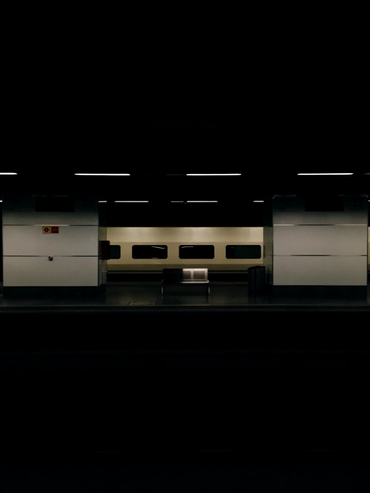 gray metal bench at the train station