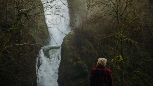 woman looking at the waterfalls photo