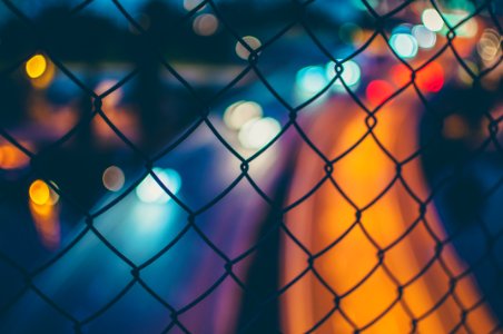 chain link fence with bokeh lights photo