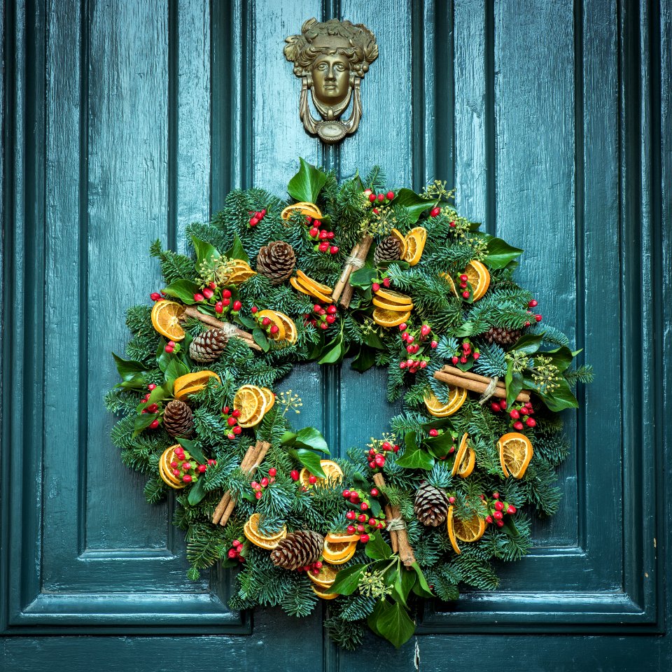 photo of green door wreath mounted in green wooden door photo