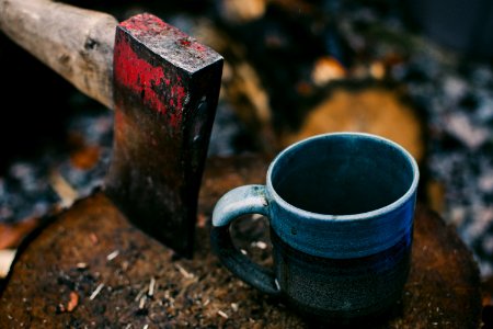 brown handled axe near gray and black ceramic cup photo