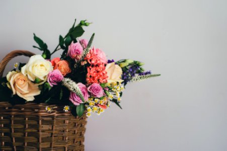 assorted-color flowers on brown wicker basket photo