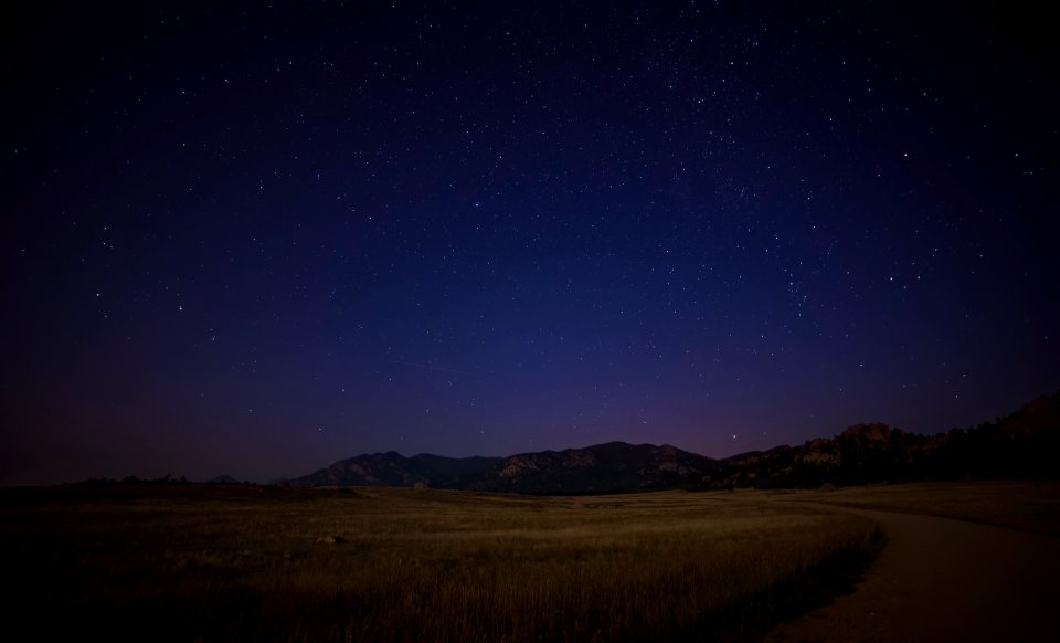 green grass field near mountain at night time photo