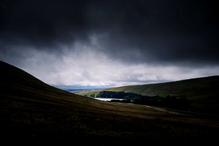 brown mountain under cumulos clouds photo