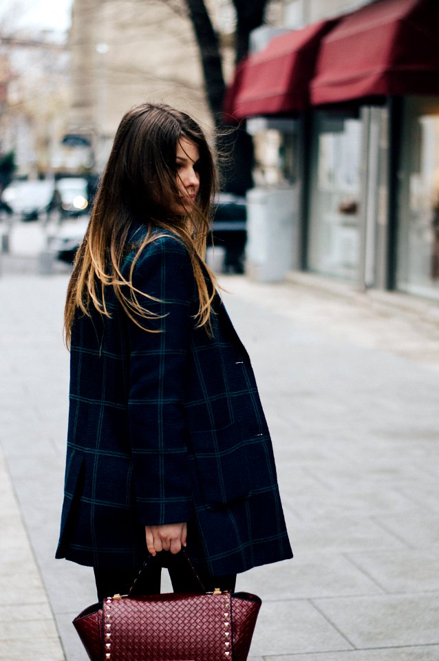 woman holding brown leather bag in bokeh photography photo