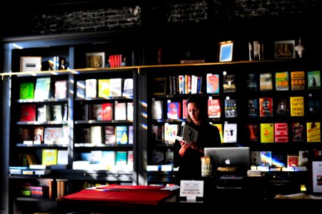 woman standing in front of book shelf photo