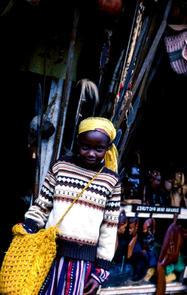 boy carrying yellow knitted bag