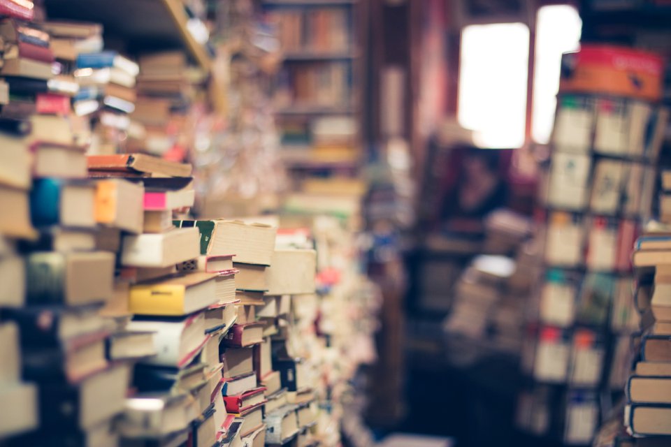 assorted books in shallow focus photography