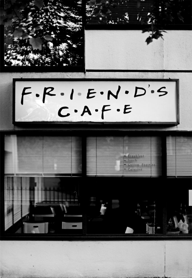 gray scale photo of Friends Cafe store