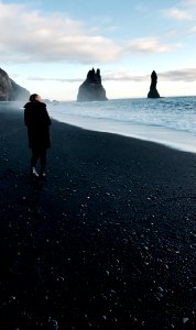 person walking near body of water