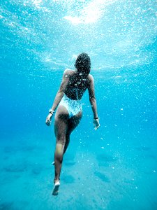 woman swimming under water
