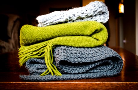 three gray, green, and white scarf on top of table photo