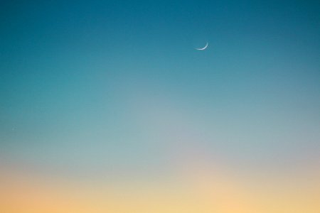 crescent moon on blue sky