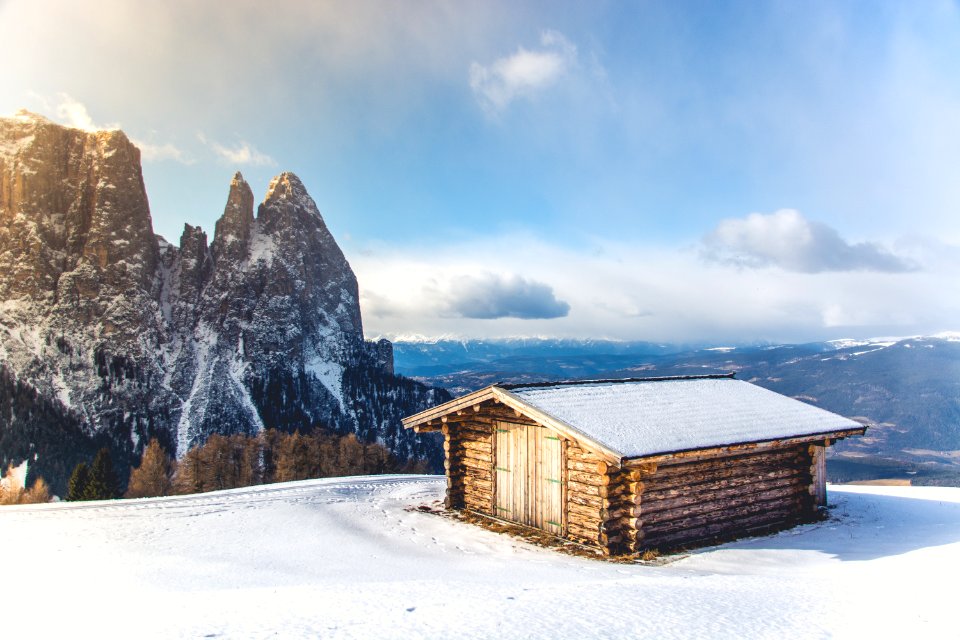 brown wooden house covered with snow