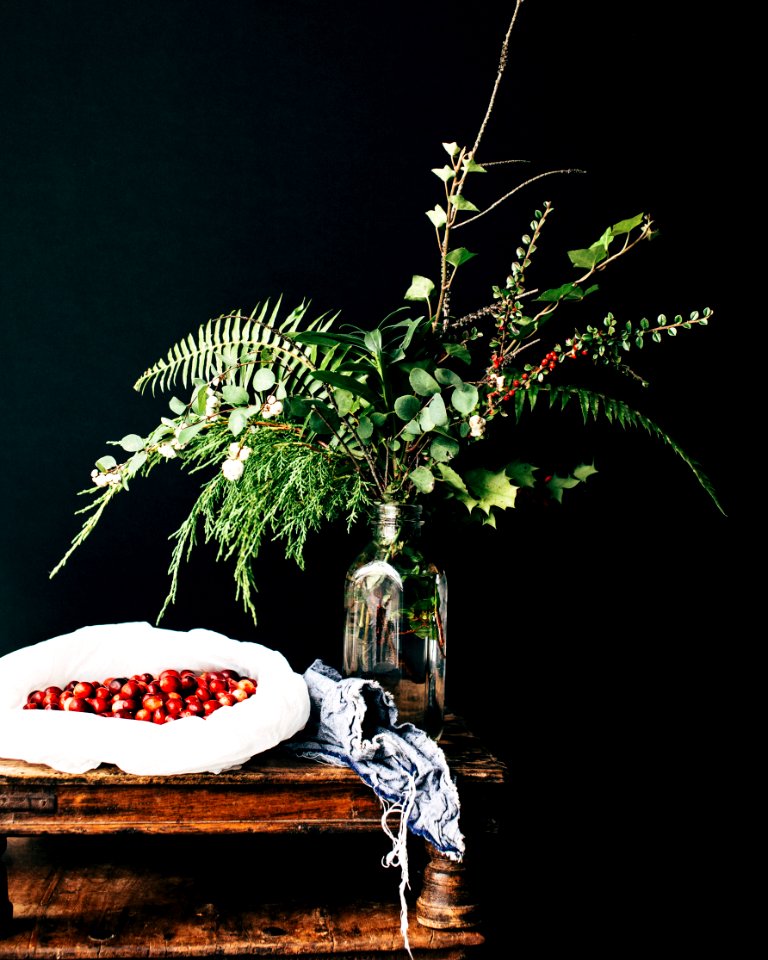 green leafed plant on clear glass bottle on top of table photo