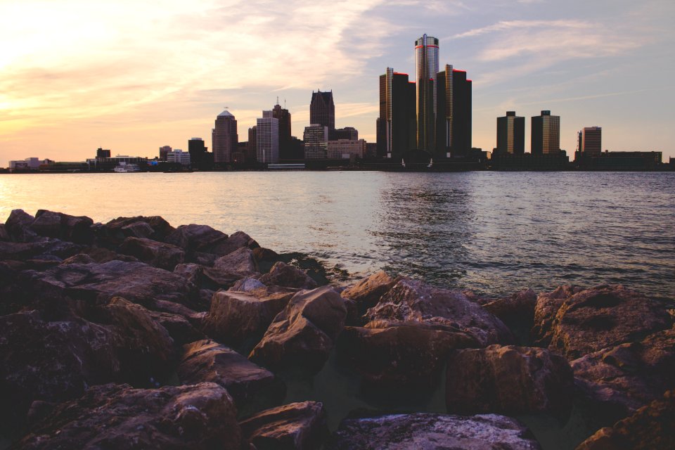 skyline photography of city buildings under blue and white cloudy skies at daytime