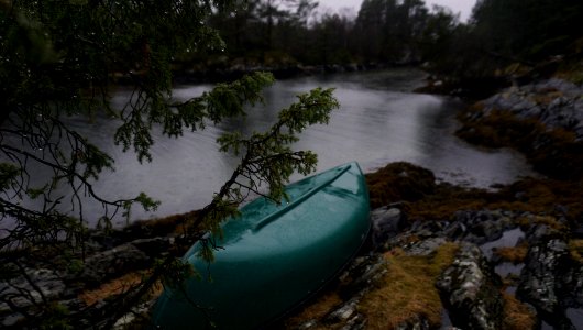green kayak on rocky river