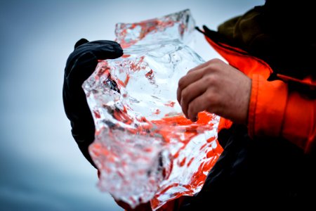 person holding clear crystal